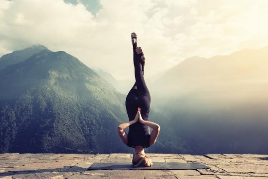 Young Woman Doing Complex Yoga Exercise Headstand with Namaste Asana_ unframed