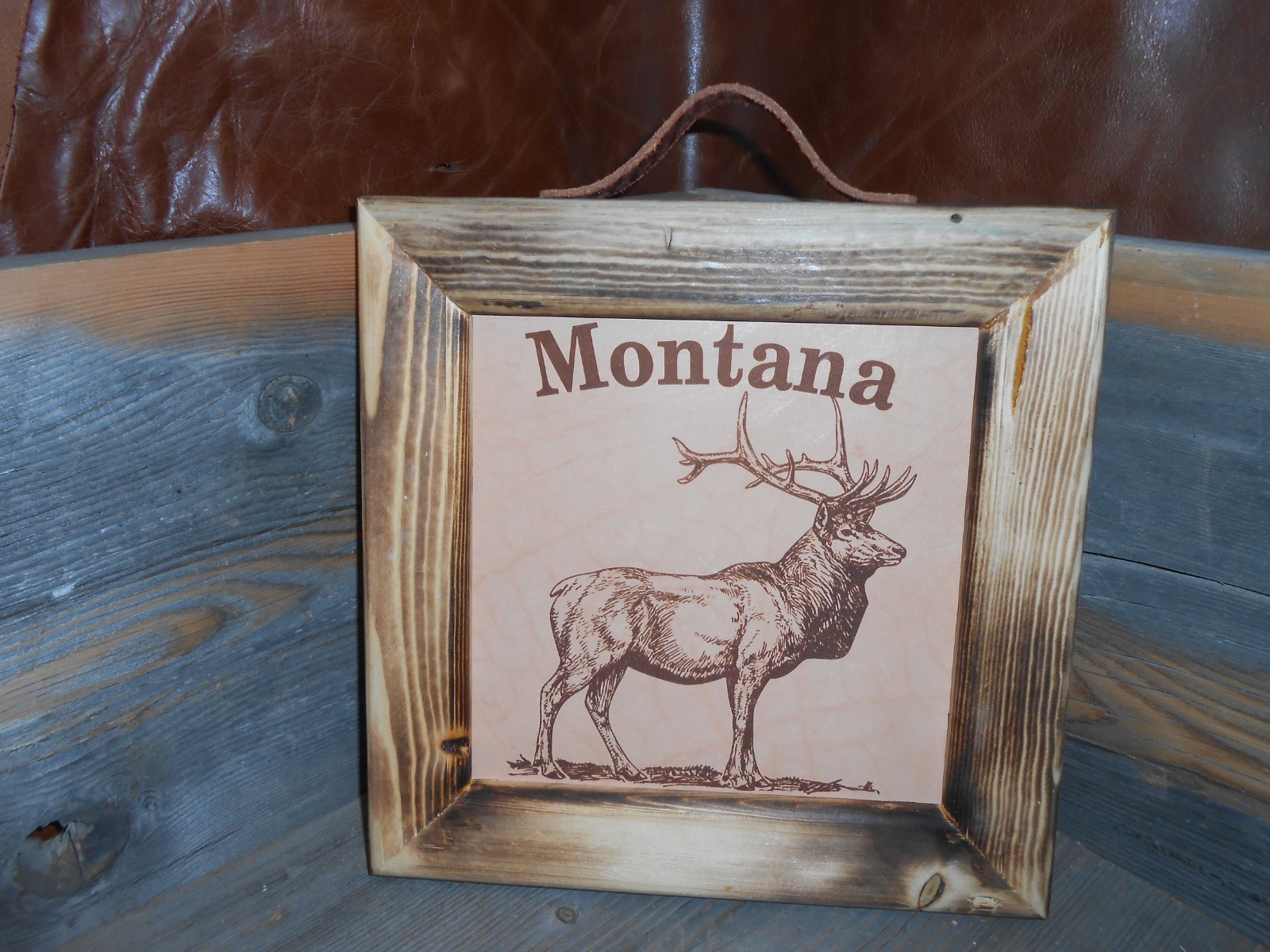 New. Montana elk picture lasered in real leather with handmade burnt wood frame
