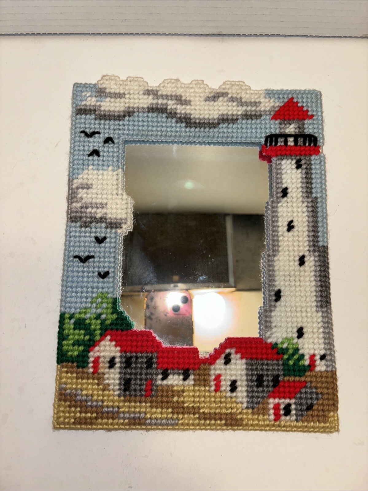 Mirror With A Needlepoint Lighthouse House Design Framing It 10 In X 7.5 In