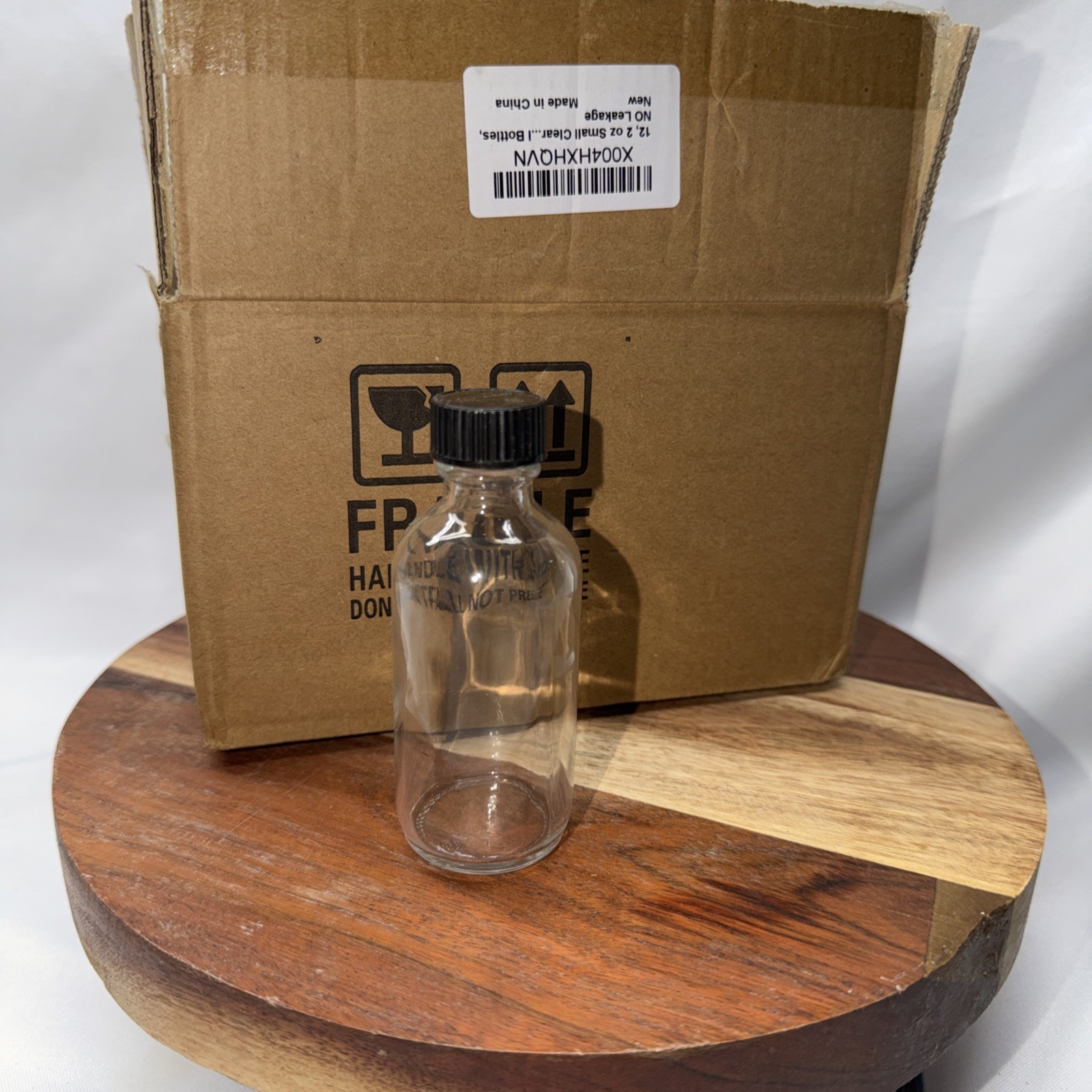 12-Pack Clear Glass Bottles with Black Caps 2oz NEW