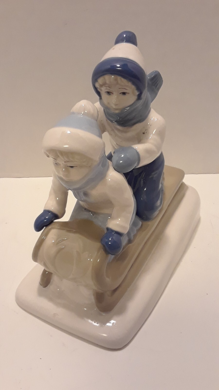 1992 PAUL SEBASTIAN PORCELAIN BOY & GIRL SLEDDERS 6 1/4″ H X 6″ L