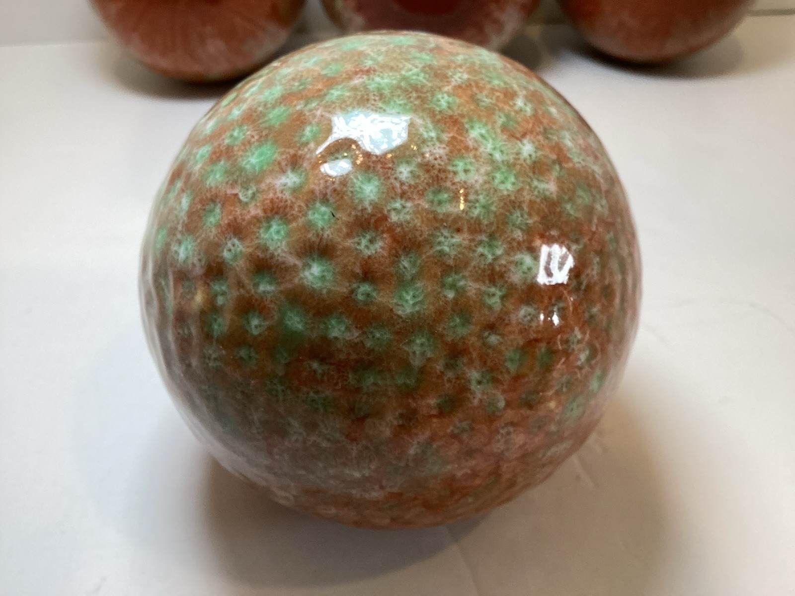 Set of 4 Glazed Ceramic 3.25” Decorative Balls in Rust and Green Colors